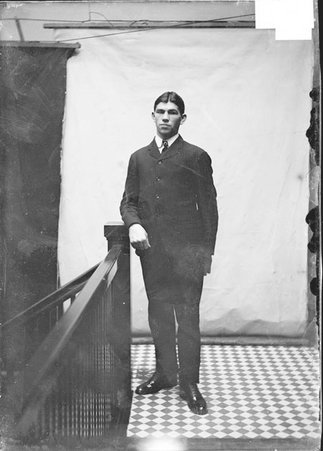 Pugilist, Martin Canole, right hand in pocket, standing in Chicago Daily News hallway - Chicago Daily News, Inc.