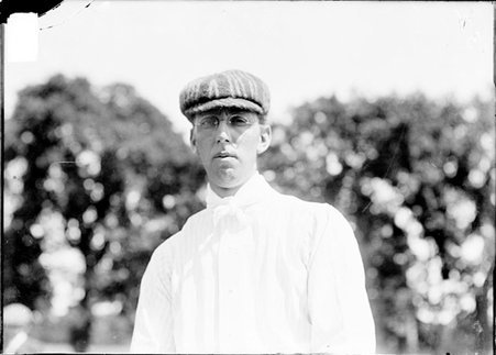 Golfer, W.L. Fisher, standing on grounds of Esmoor Golf Club - Chicago Daily News, Inc.