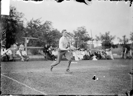 Tennis player, Edward Ashcraft, running on backcourt during match - Chicago Daily News, Inc.