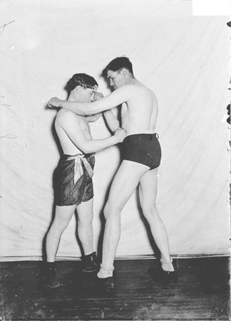 Pugilist, Buddy Ryan, stepping inside left punch, blocking right punch, countering to body - Chicago Daily News, Inc.