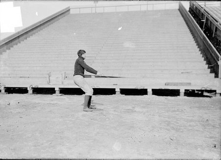 Football player, Tobin, hands together, arms outstretched, facing bleachers - Chicago Daily News, Inc.