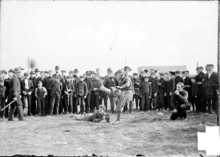 Football game, Englewood High School-West Division High School, player punting, ball in air - Chicago Daily News, Inc.