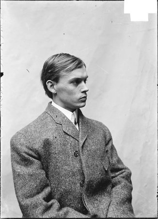 Pugilist, Kid Finucan, in profile, sitting in front of a light colored backdrop - Chicago Daily News, Inc.