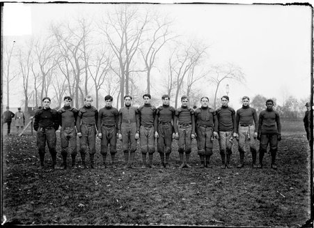 Football team, North Division High School, standing in a line, dark exposure - Chicago Daily News, Inc.