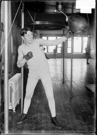 Pugilist, Jack O Keefe, hitting punching bag - Chicago Daily News, Inc.