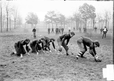 Football team, Englewood High School, five players snapping the ball - Chicago Daily News, Inc.