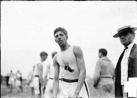 Athlete, Harry L. Hillman, New York University, standing near other athletes on athletic field, facing the camera - Chicago Daily News, Inc.