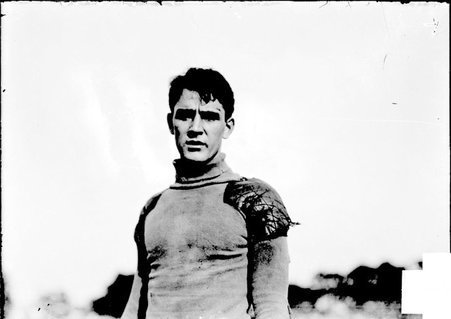 Football player, McPherrin, Northwestern University, standing on athletic field - Chicago Daily News, Inc.