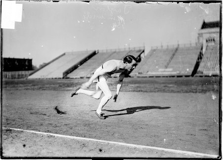 Athlete, Taylor, running on a track across the field from bleachers, Marshall Field - Chicago Daily News, Inc.