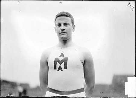 Athlete, Nicol, University of Michigan, standing at Marshall Field - Chicago Daily News, Inc.