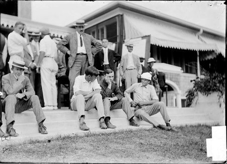 Golf grounds, Onwentsia Country Club, men sitting and standing on patio - Chicago Daily News, Inc.