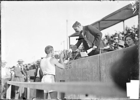 Athlete, Charles Dvorak, University of Michigan, receiving trophy from official, 1904 Olympic Games - Chicago Daily News, Inc.