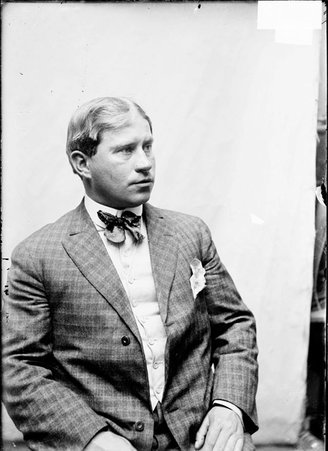 Trainer, Tom McGrath, sitting in profile - Chicago Daily News, Inc.