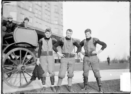 Football team, University of Minnesota, three players standing near carriage by Chicago Beach Hotel - Chicago Daily News, Inc.