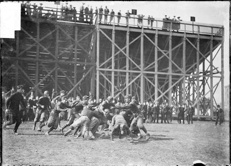 Football game, Oak Park High School-Hyde Park High School, tackle behind bleachers - Chicago Daily News, Inc.
