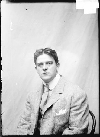 Athlete, W. W. Coe, sitting in hallway - Chicago Daily News, Inc.