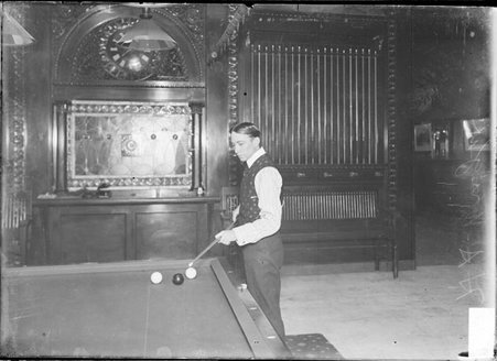 Billiards, H. A. Wright, standing upright, considering a shot from a corner - Chicago Daily News, Inc.