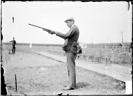 Marksman, E. B. Shogren, pointing rifle, standing at the rifle range - Chicago Daily News, Inc.