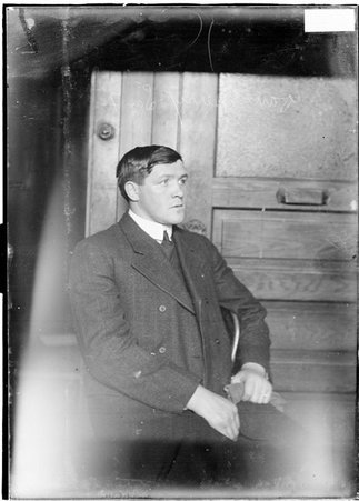 Dave Berry, looking to his left, sitting against a door - Chicago Daily News, Inc.