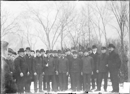 Skiing, men gathered on snowy hill, Humboldt Park - Chicago Daily News, Inc.