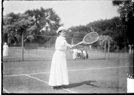 Tennis player, Miss Miriam Stecver, extending her racket before her, standing in backcourt - Chicago Daily News, Inc.