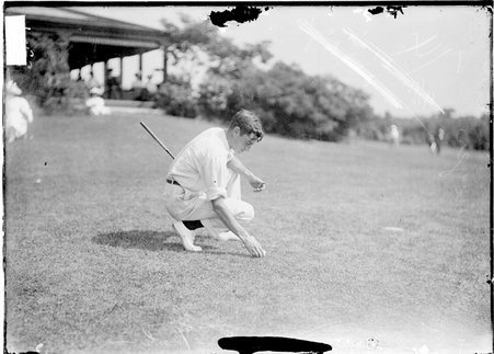 Golfer, D. E. Sawyer, setting ball to tee off - Chicago Daily News, Inc.