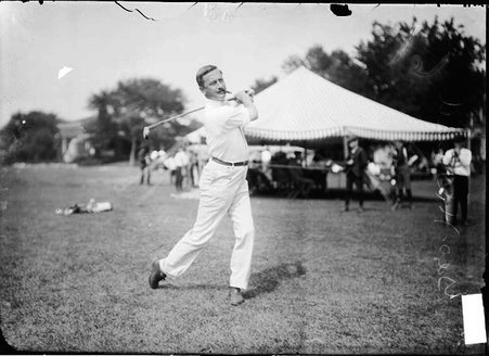 Golfer, George H. Russell, swinging golf club behind his back - Chicago Daily News, Inc.