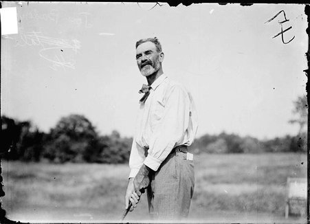 Golfer, Joseph Badenoch, holding golf club - Chicago Daily News, Inc.