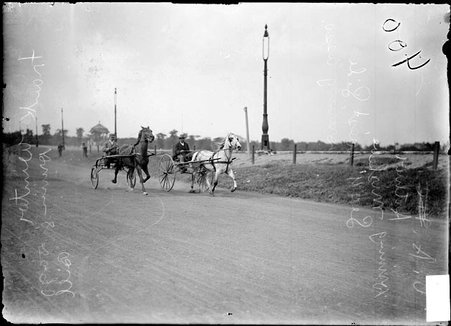 Drivers A. O. Arthur, at the reins of racehorse Mishebe, and Frank Winter at the reins of racehorse Dago Bill, in two-wheeled carts - Chicago Daily News, Inc.