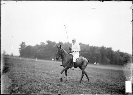Polo player, Col. W. W. Rathborne, riding on horse with polo mallet pointed straight up - Chicago Daily News, Inc.