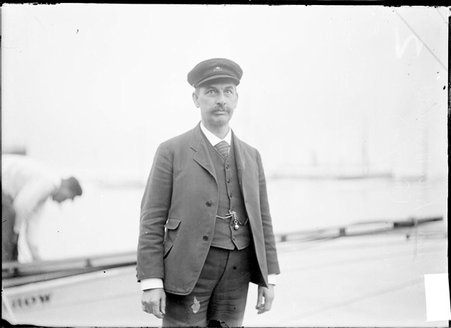 Yacht racer, Capt. D. A. McDonald, standing on a pier - Chicago Daily News, Inc.