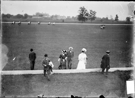 Polo scene, spectators crossing low fence from playing field - Chicago Daily News, Inc.