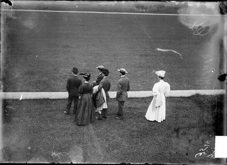 Polo scene, spectators watching from behind low fence - Chicago Daily News, Inc.