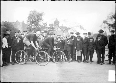 Cyclists, balancing on bikes at the start of a race - Chicago Daily News, Inc.