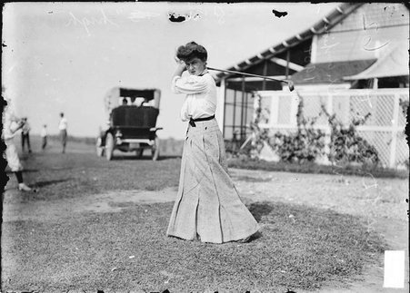 Golfer Miss T. D. Everett, posing with a golf club over her shoulder at Hinsdale Golf Club in Clarendon Hills, Illinois - Chicago Daily News, Inc.