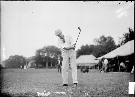 Golfer, H. B. Smith, leaning over, swinging golf club - Chicago Daily News, Inc.