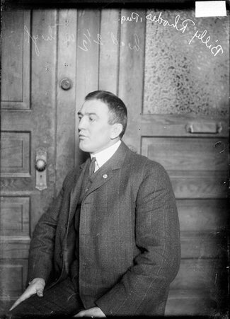 Pugilist, Billy Rhodes, sitting sideways in a room - Chicago Daily News, Inc.