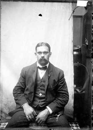 Wrestler, Butcher Boy, facing camera, sitting against a plain backdrop - Chicago Daily News, Inc.