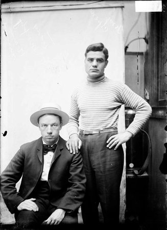 Boxers Tony Caponi and Teddy Murphy, posing in front of a plain backdrop in a stairwell hallway at the Chicago Daily News - Chicago Daily News, Inc.