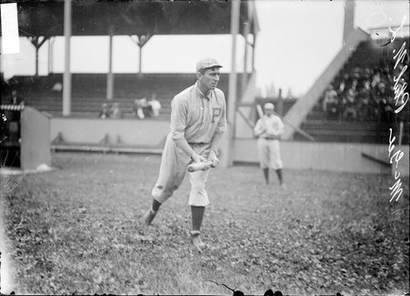 Philadelphia Phillies outfielder Sherry Magee, holding a bat in bunting position during warm up in the foul zone at West Side Grounds - Chicago Daily News, Inc.