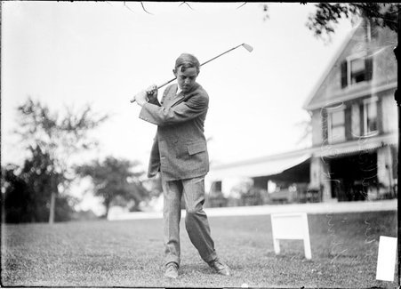 Golfer, Loren Hubbard, preparing to swing, on lawn near clubhouse, Westward Ho Golf Club - Chicago Daily News, Inc.