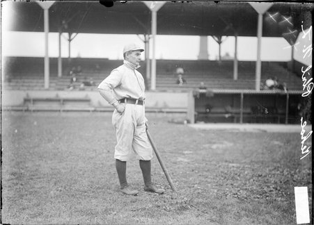 Philadelphia Phillies baseball player Mike Kahoe, holding a bat at his side in the foul zone behind home plate at West Side Grounds - Chicago Daily News, Inc.