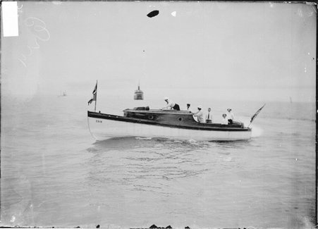 Motorboat, Erin, holding six unidentified passengers standing on deck, floating in Lake Michigan - Chicago Daily News, Inc.