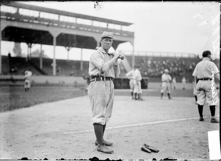 Philadelphia Phillies second baseman Kid Gleason, standing with a bat over his shoulder on the field at West Side Grounds - Chicago Daily News, Inc.