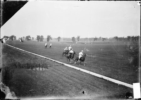 Polo players on the left end of the field, riding ponies toward the center of the field, at an unidentified polo field - Chicago Daily News, Inc.
