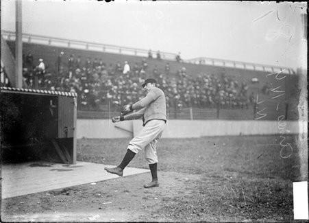 New York Giants baseball player Leon Kessling (Red) Ames, standing near the dugout warming up at West Side Grounds - Chicago Daily News, Inc.
