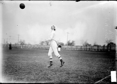 Soccer player, J. C. Warbrick, jumping to head the ball on an athletic field - Chicago Daily News, Inc.