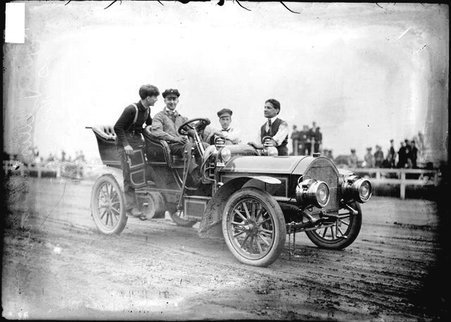 Driver, Jerry Ellis and three men sitting in an automobile on a racetrack - Chicago Daily News, Inc.
