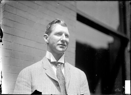 University of Wisconsin crew coach, O'Dea, standing in front of a brick building - Chicago Daily News, Inc.