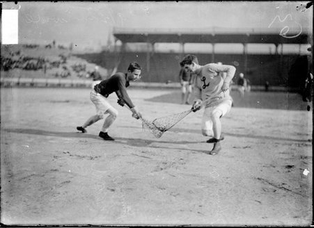 Lacrosse players Meyer, and W. G. Dunseyth, of the London, Canada team, standing with their sticks touching at a match, South Side Park - Chicago Daily News, Inc.